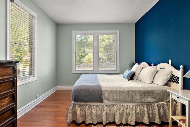 bedroom featuring wood finished floors and baseboards