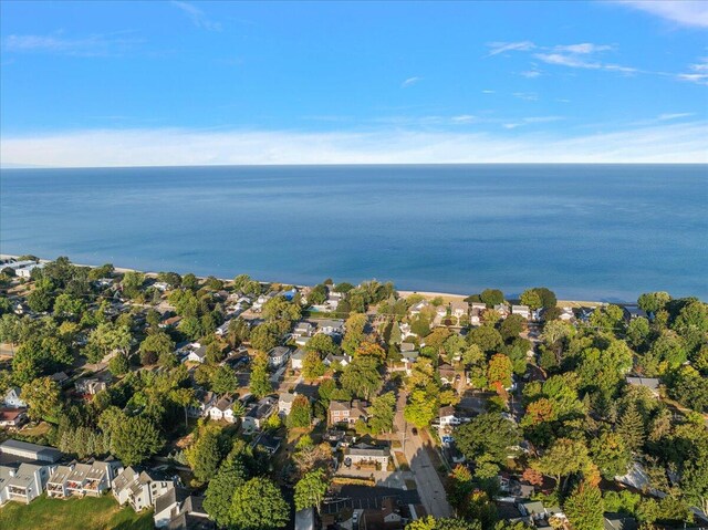 drone / aerial view featuring a water view and a residential view