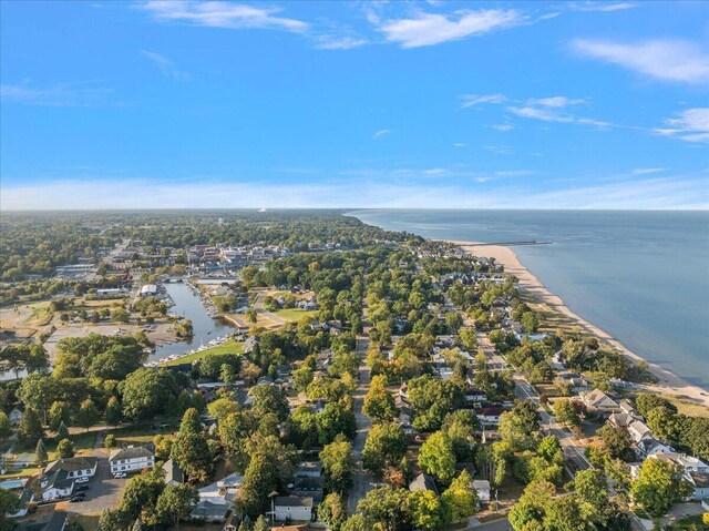 drone / aerial view with a water view and a beach view