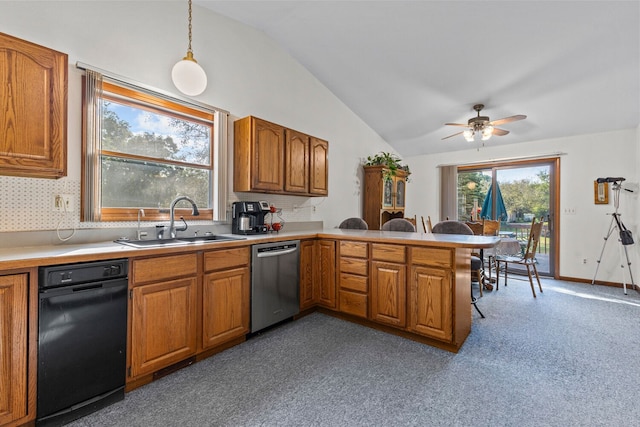 kitchen featuring stainless steel dishwasher, lofted ceiling, kitchen peninsula, and sink