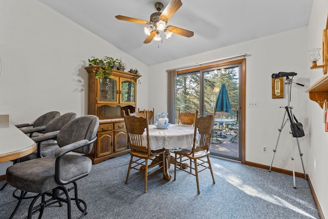 dining space with light colored carpet, vaulted ceiling, and ceiling fan