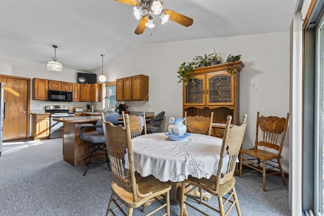 dining room featuring carpet flooring, ceiling fan, and vaulted ceiling