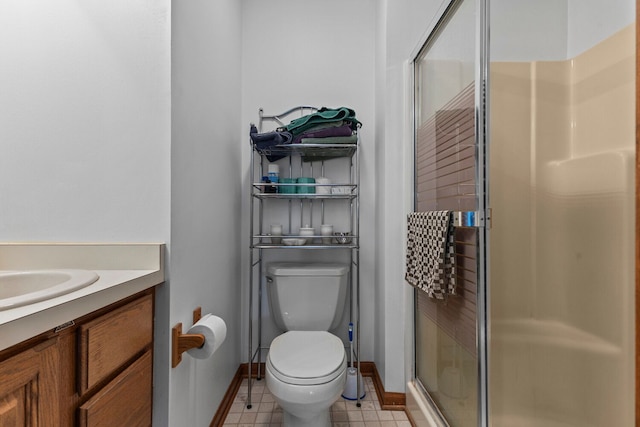 bathroom featuring vanity, toilet, and walk in shower