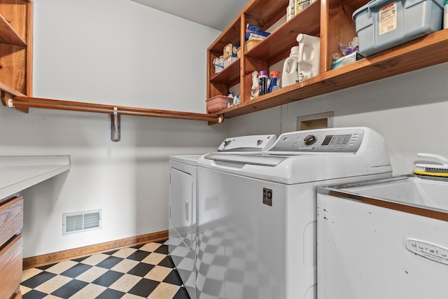 laundry room with washer and dryer and sink