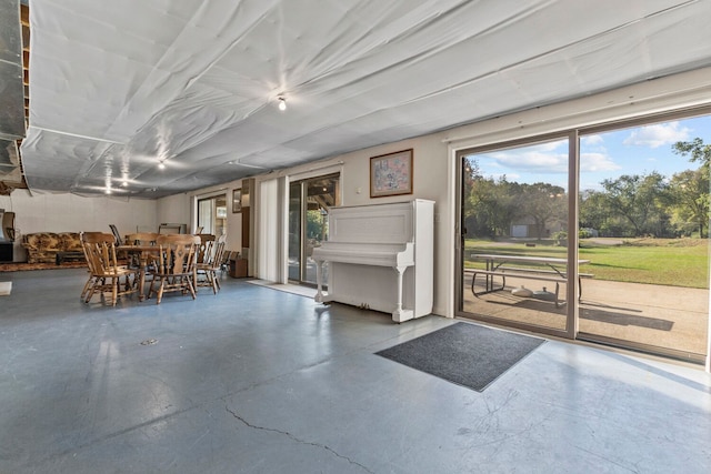 unfurnished dining area featuring concrete flooring