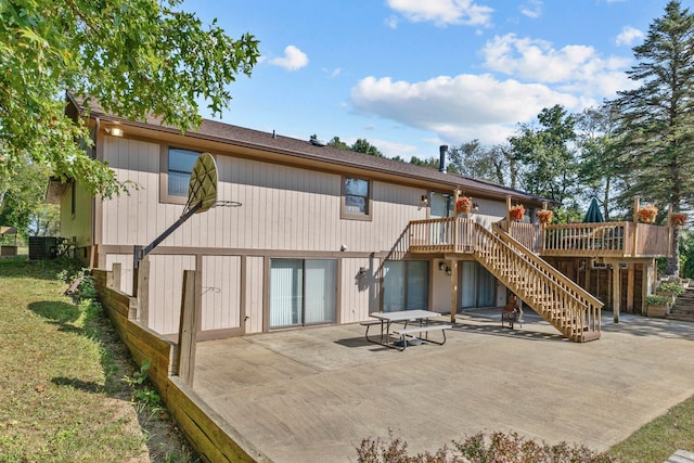 back of house with a patio area and a deck