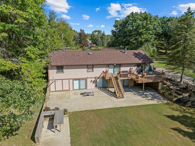 back of house featuring a yard, a patio area, and a wooden deck