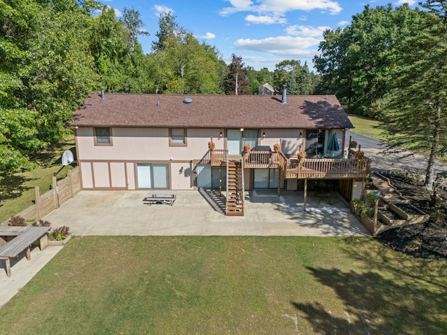 back of property with a patio area, a yard, and a wooden deck