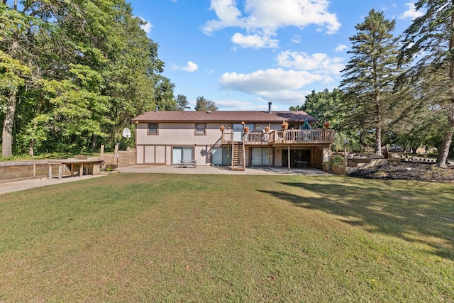 back of house featuring a patio, a deck, and a lawn