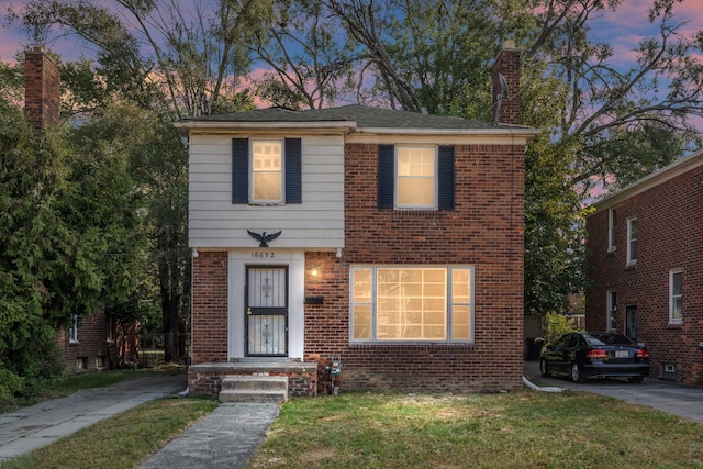 16652 Hubbell St, Detroit, MI 48235 - view of front of home with a chimney, brick siding, and a lawn