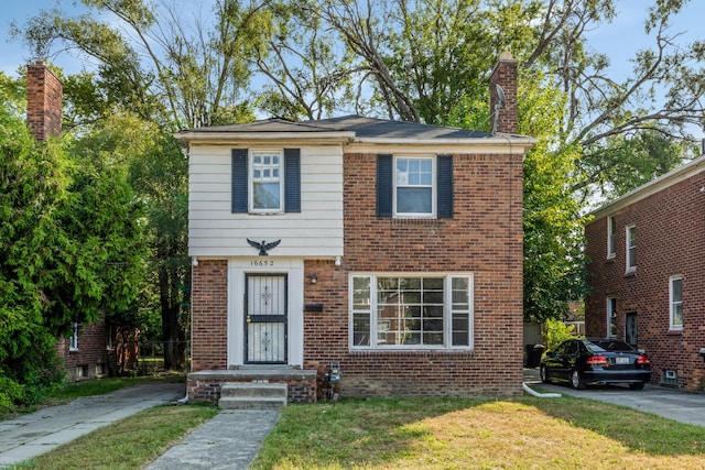 16652 Hubbell St, Detroit, MI 48235 - view of front of home featuring a chimney, brick siding, and a front lawn