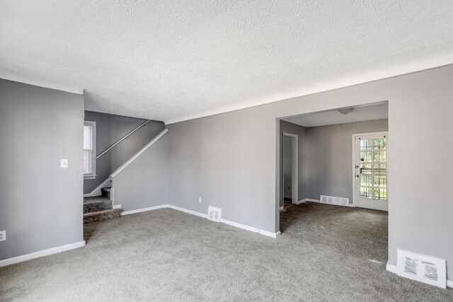 16652 Hubbell St, Detroit, MI 48235 - unfurnished living room with carpet flooring, stairway, a textured ceiling, and baseboards