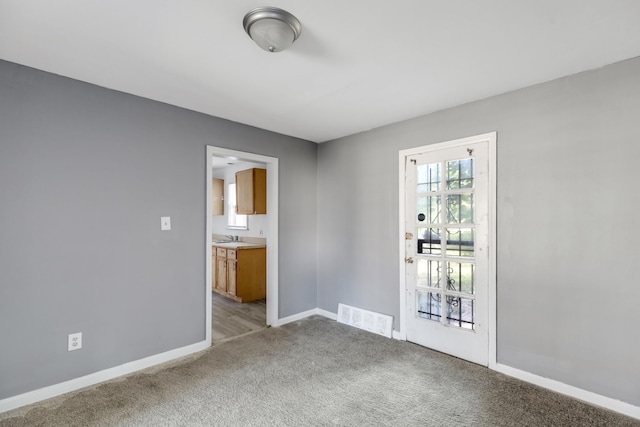 carpeted empty room featuring sink