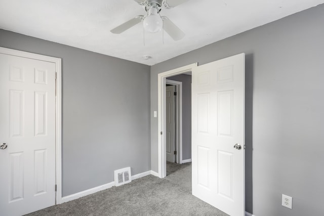 unfurnished bedroom with light colored carpet and ceiling fan