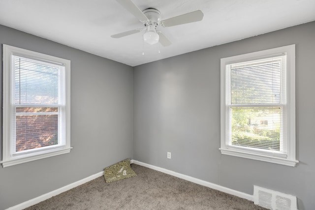 carpeted spare room with ceiling fan