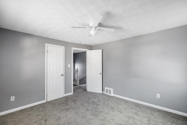 empty room with carpet flooring and ceiling fan