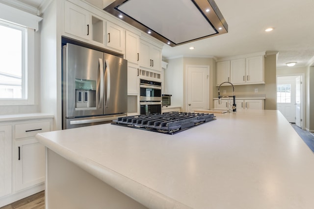 kitchen featuring plenty of natural light, white cabinets, and appliances with stainless steel finishes