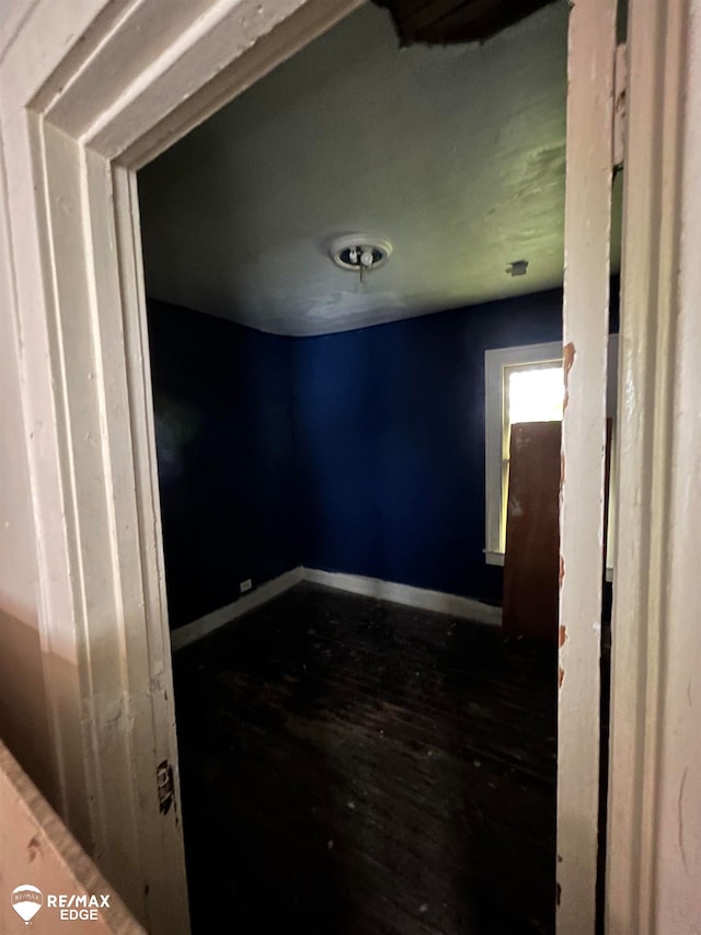 spare room featuring dark hardwood / wood-style flooring