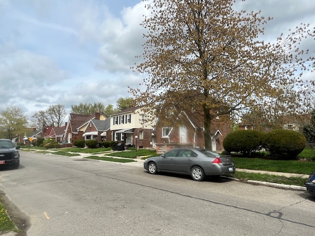 view of street featuring a residential view, curbs, and sidewalks