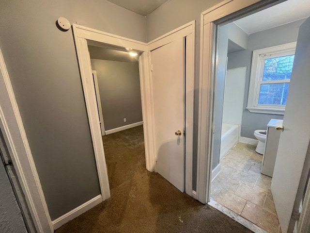 hall with carpet and baseboards