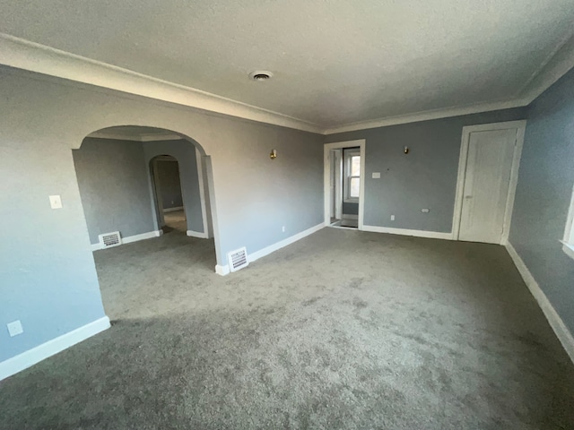 carpeted empty room featuring arched walkways, baseboards, and visible vents
