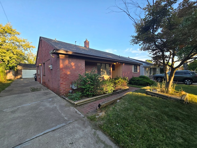 view of home's exterior featuring a garage, a yard, and an outbuilding