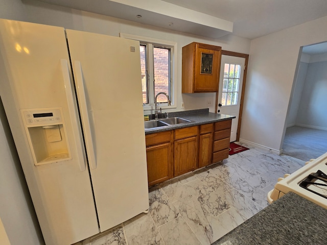 kitchen featuring white appliances, a healthy amount of sunlight, and sink