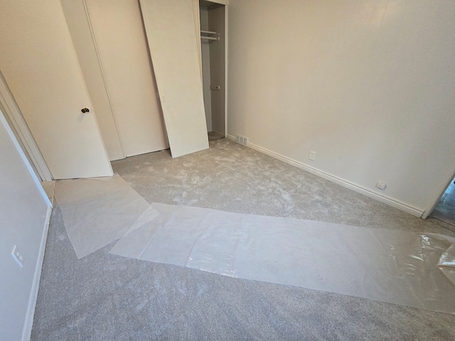 unfurnished bedroom featuring light carpet