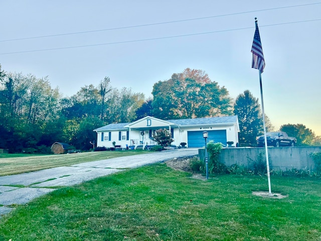 view of front of property featuring a garage and a front lawn