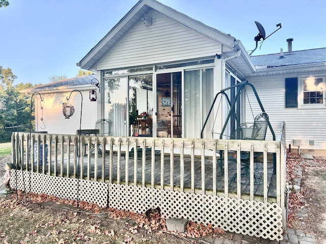 view of front facade with a sunroom and a deck