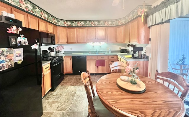 kitchen with light brown cabinets, sink, and black appliances