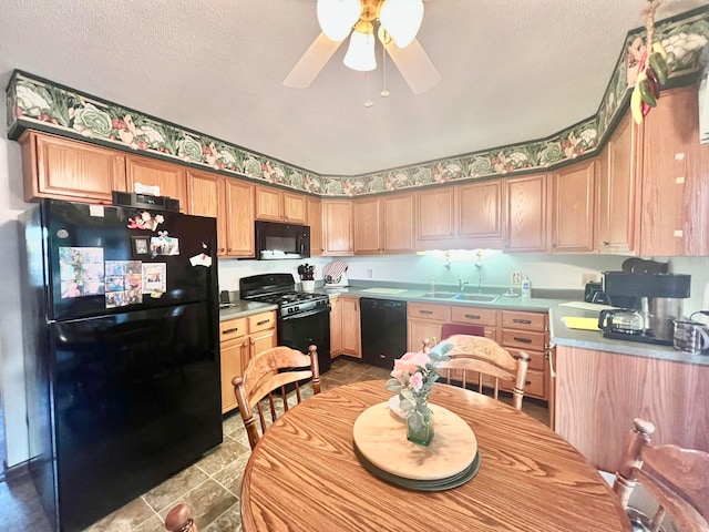 kitchen with ceiling fan, sink, black appliances, and a textured ceiling