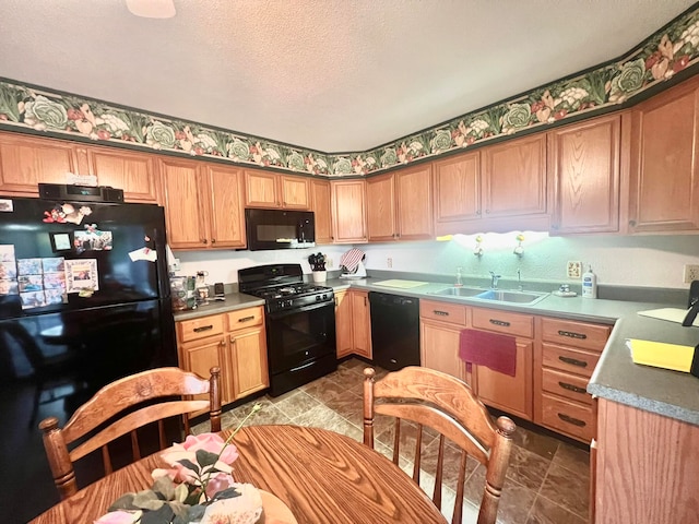 kitchen with a textured ceiling, sink, and black appliances