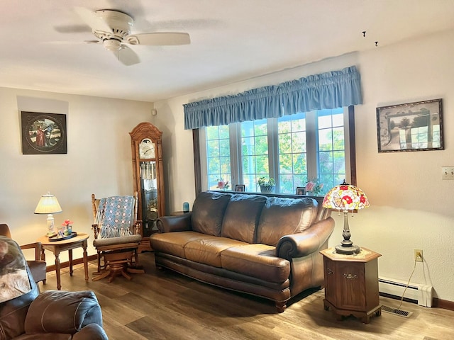 living room featuring baseboard heating, ceiling fan, and light hardwood / wood-style floors