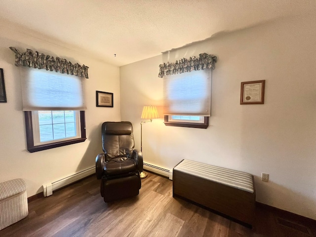 sitting room with hardwood / wood-style floors and a baseboard radiator