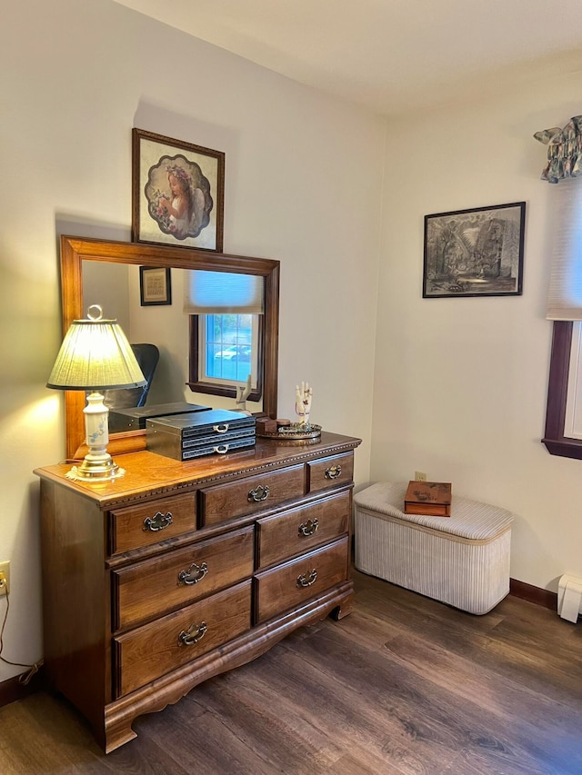 bedroom with dark wood-type flooring