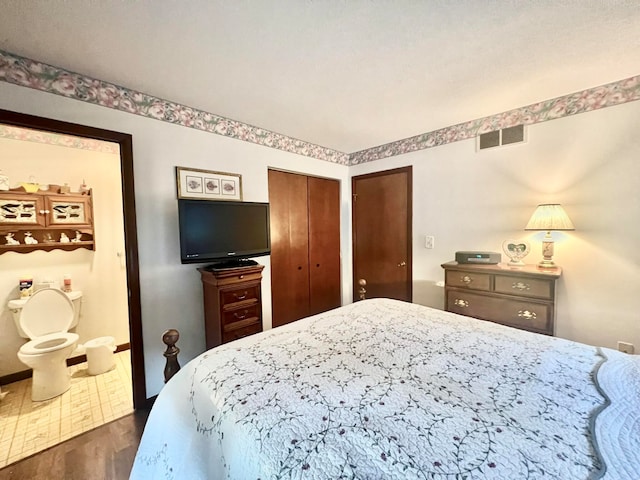 bedroom featuring a closet and dark hardwood / wood-style floors