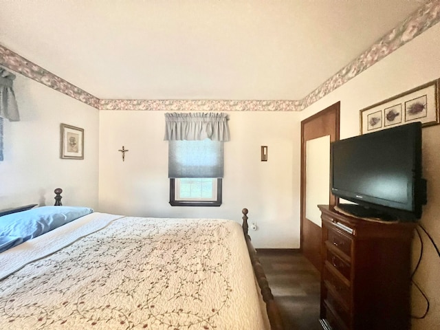 bedroom with wood-type flooring