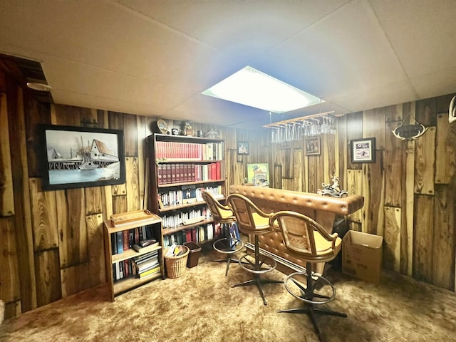 office area featuring bar and wood walls