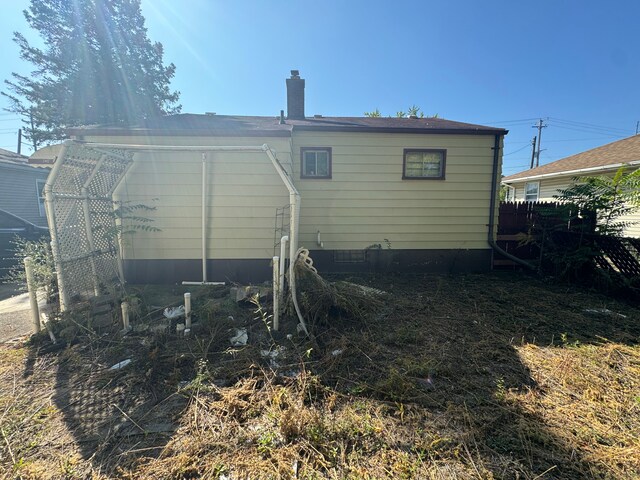 1408 W Pasadena Ave, Flint, MI 48504 - rear view of house featuring a chimney
