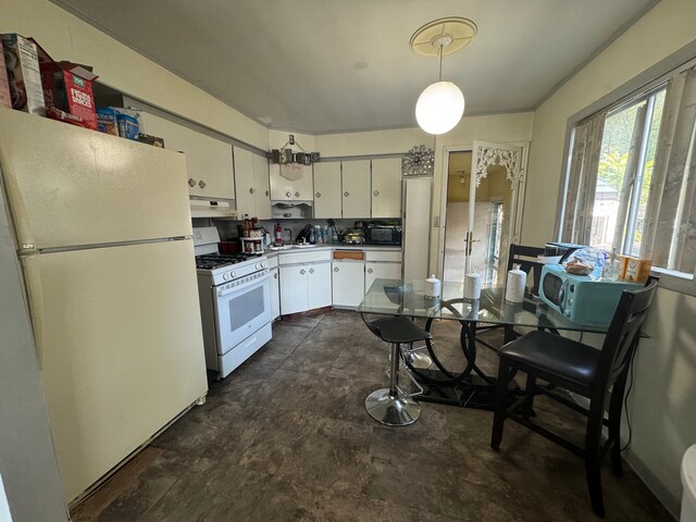 1408 W Pasadena Ave, Flint, MI 48504 - kitchen with white appliances, under cabinet range hood, white cabinetry, hanging light fixtures, and light countertops