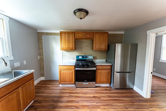 kitchen featuring hardwood / wood-style floors, stainless steel appliances, a wealth of natural light, and sink