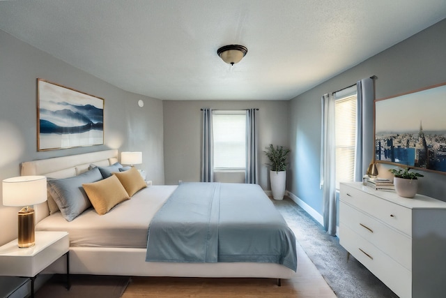 bedroom featuring hardwood / wood-style floors and a textured ceiling