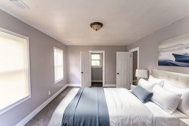 bedroom featuring a textured ceiling and carpet floors