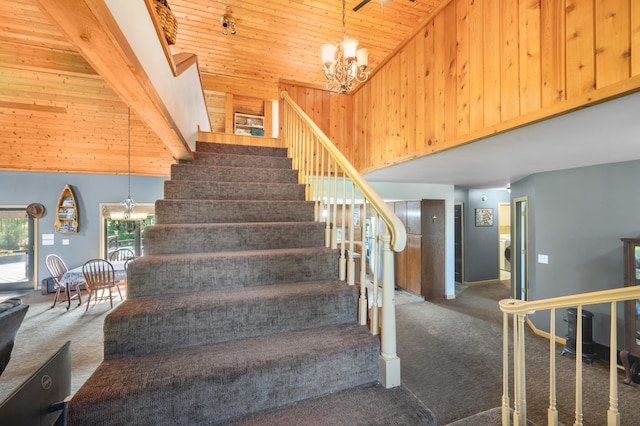 stairway with carpet floors, high vaulted ceiling, wooden ceiling, and a notable chandelier