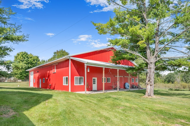 view of home's exterior with an outbuilding and a lawn