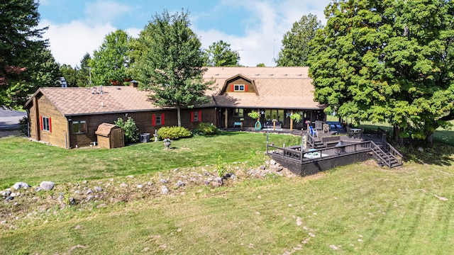 rear view of house featuring a lawn