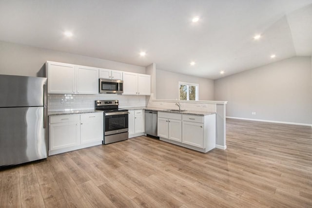 kitchen featuring white cabinets, stainless steel appliances, light hardwood / wood-style floors, and sink