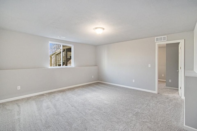 spare room featuring light colored carpet