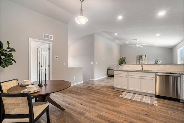 dining space featuring ceiling fan, sink, high vaulted ceiling, and dark hardwood / wood-style floors